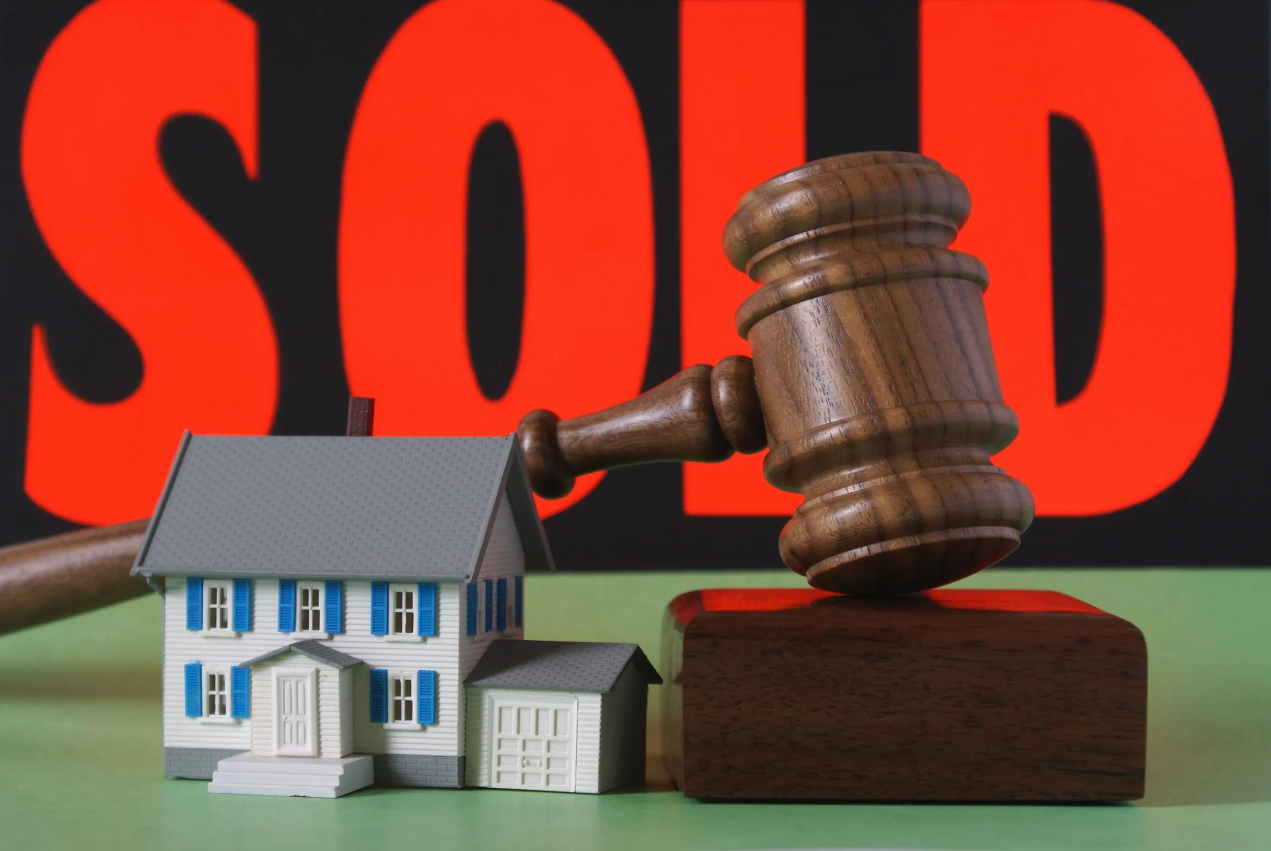 house with sold sign and gavel